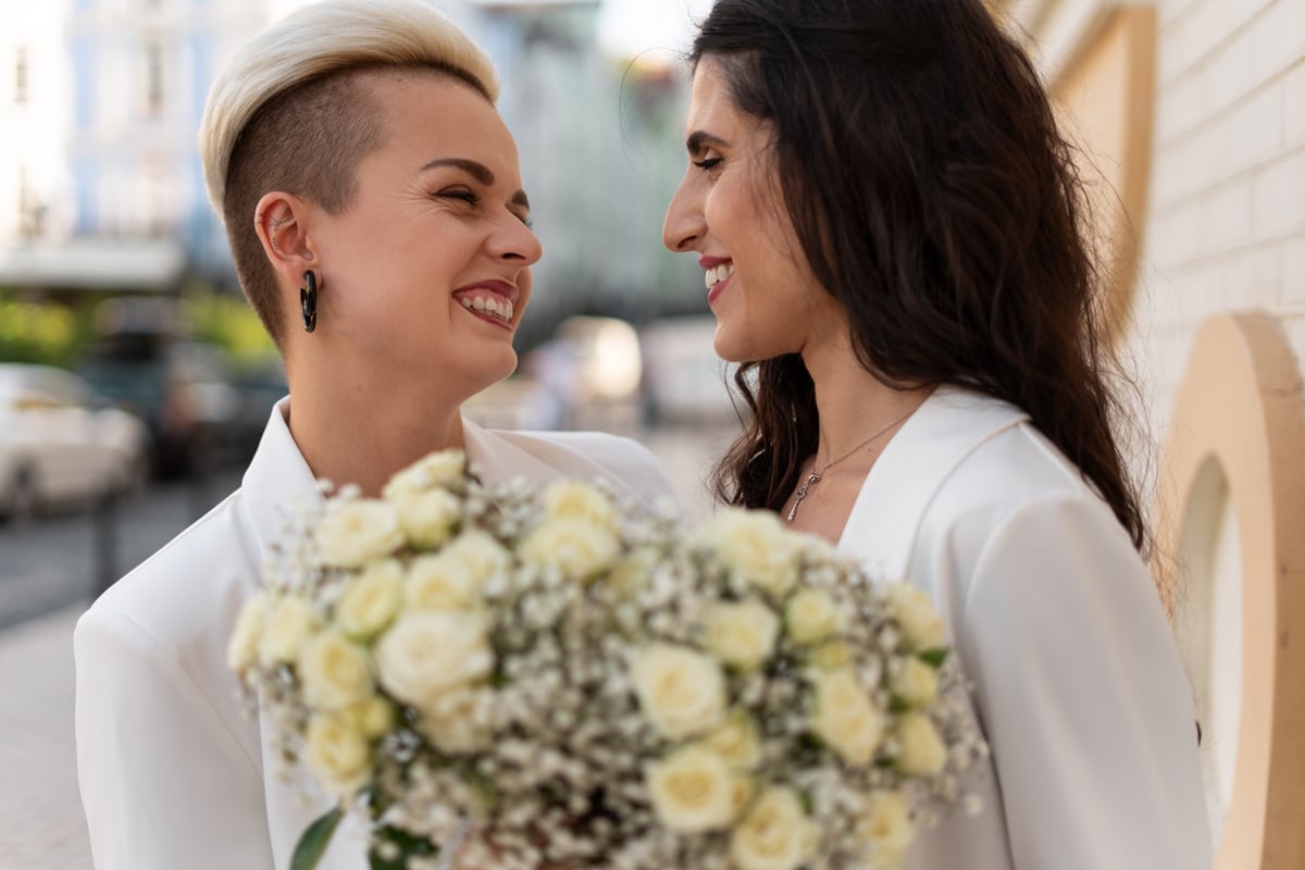 lesbian married couple smiling to each other