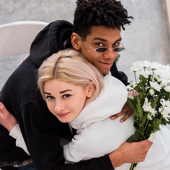 young interracial couple hugging each other
