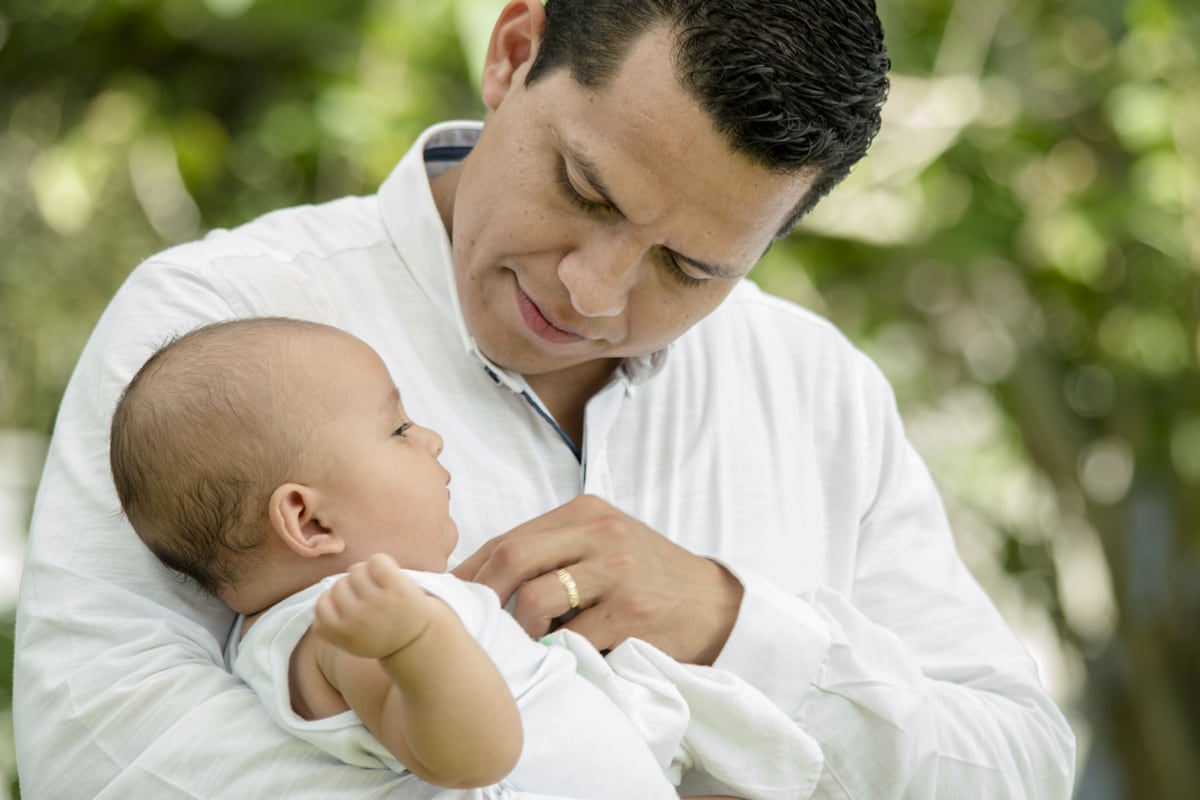 middle age man holding a baby